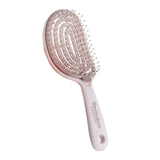 Taupe hairbrush with 'Revitalize' branding on a white background